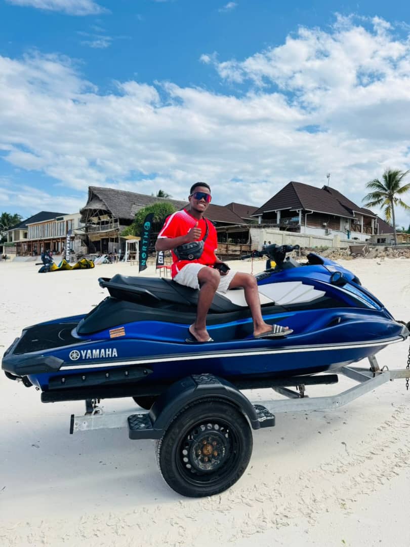 Yussuf from Paje Watersports on the beach next to a jet ski
